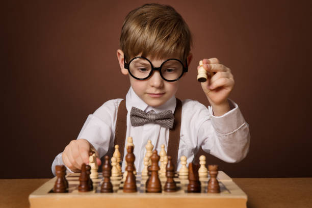 A boy thoughtfully considering his next move on a chess board, highlighting strategic thinking and cognitive enhancement, emphasizing brain development