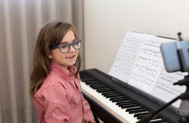 A child immersed in learning to play piano online, exemplifying the interactive and educational experience offered by MasterMindz