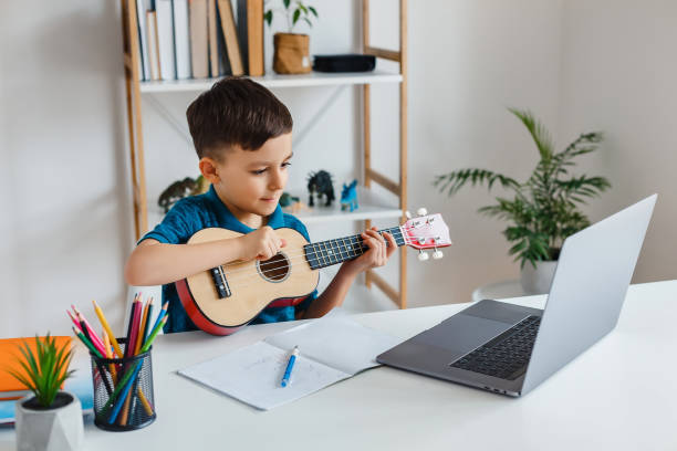 A child enthusiastically learning to play guitar online, symbolizing the accessible and engaging learning experience provided by MasterMindz