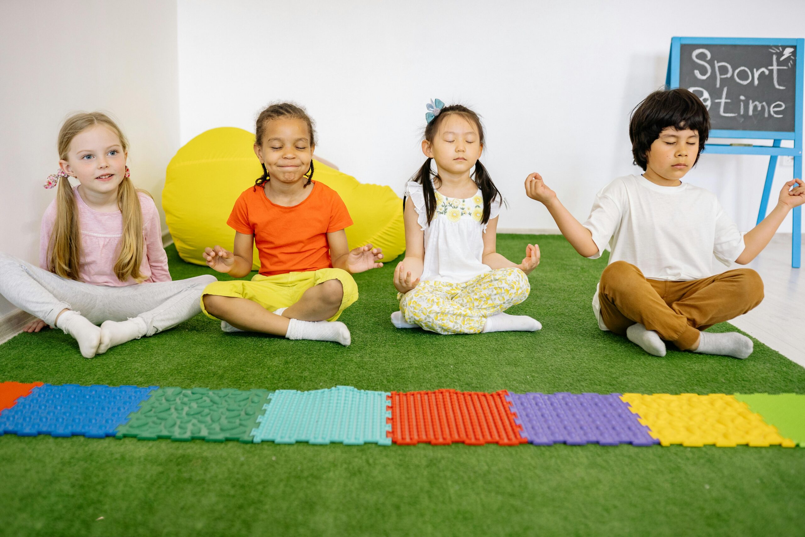 Children practicing meditation and yoga online, showcasing the serene and holistic approach to wellness education offered by MasterMindz