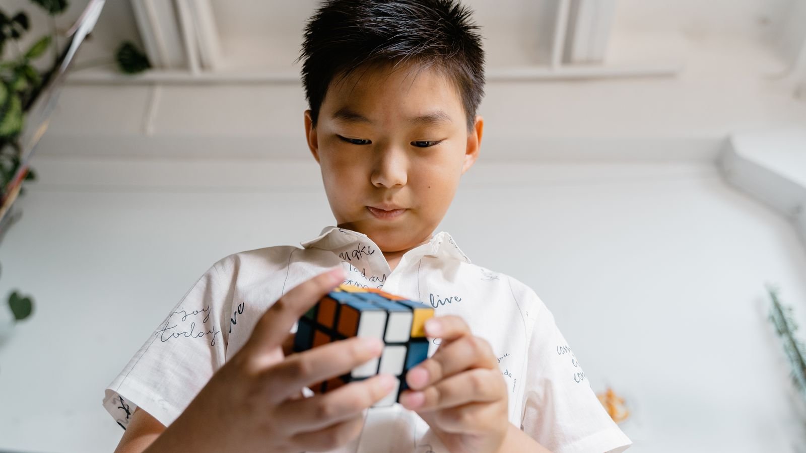 Child learning how to solve a Rubik's cube step by step