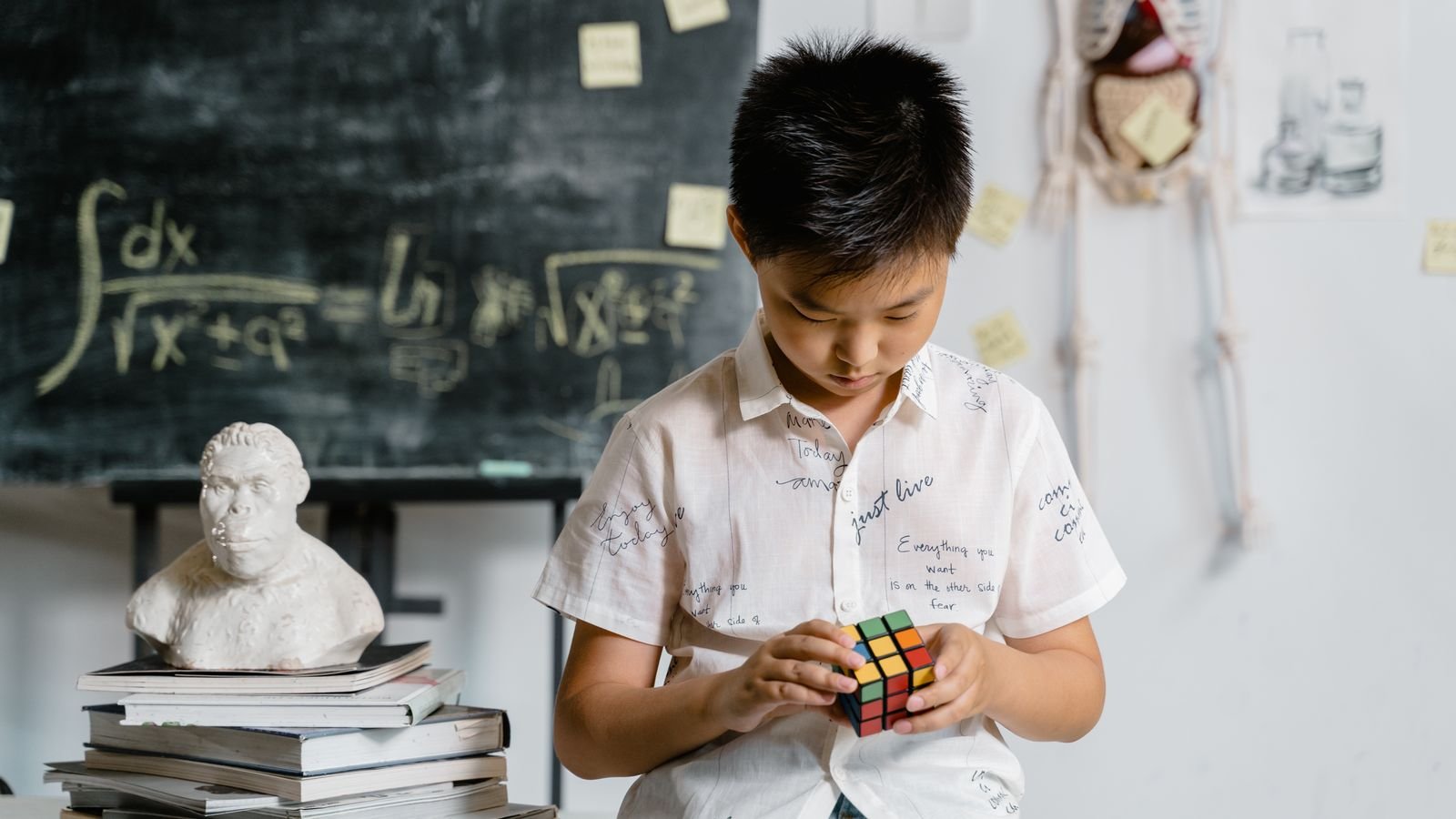 Child taking a live 1 on 1 online Rubik's cube class on a laptop