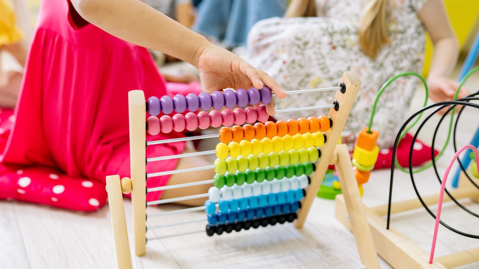 Young child using a colourful abacus during an online abacus class for kids