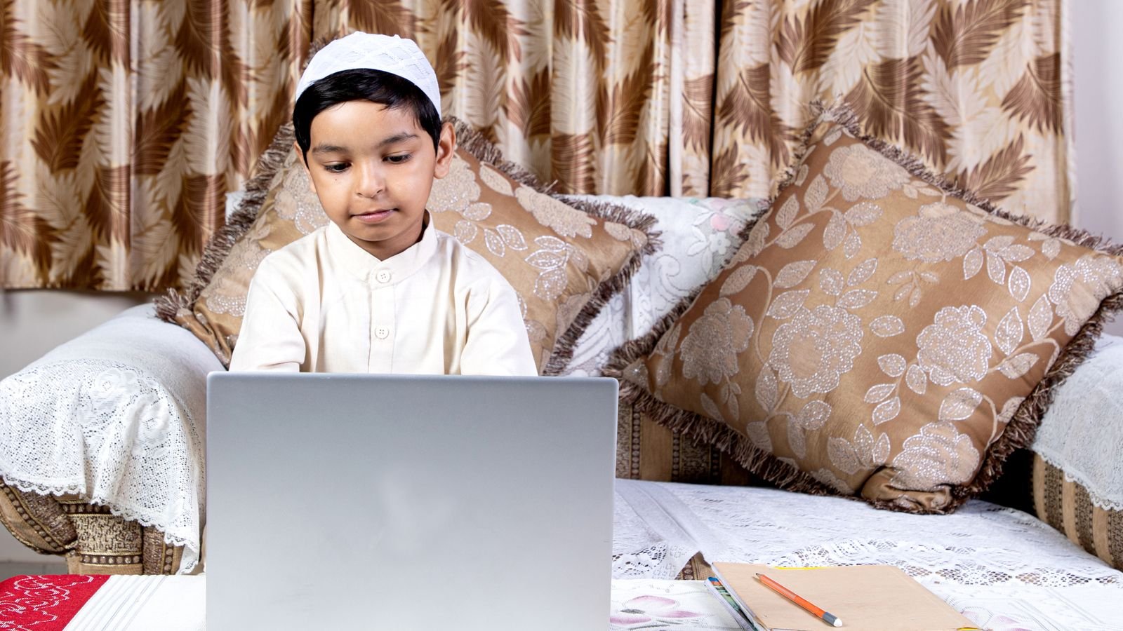 Child taking a live 1 on 1 online chess lesson on a laptop at home