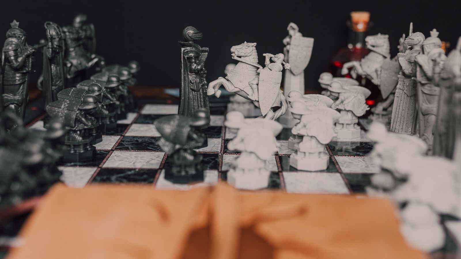 Chess board close up showing a knight in the centre, used to explain chess tactics for kids
