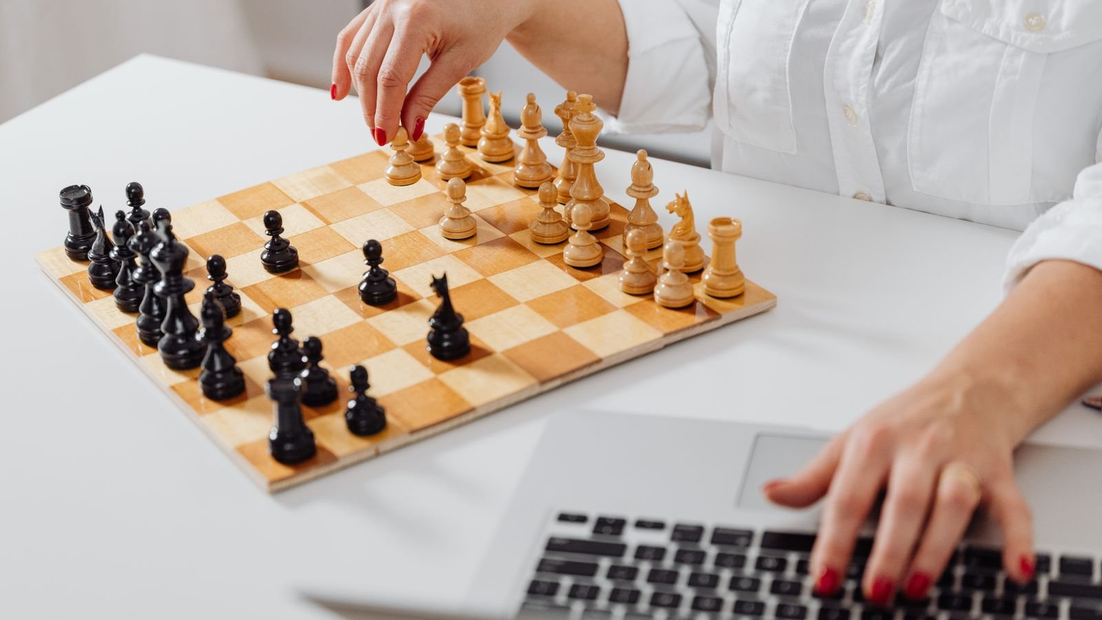 Child setting up a safe online chess account on a laptop with a parent's help