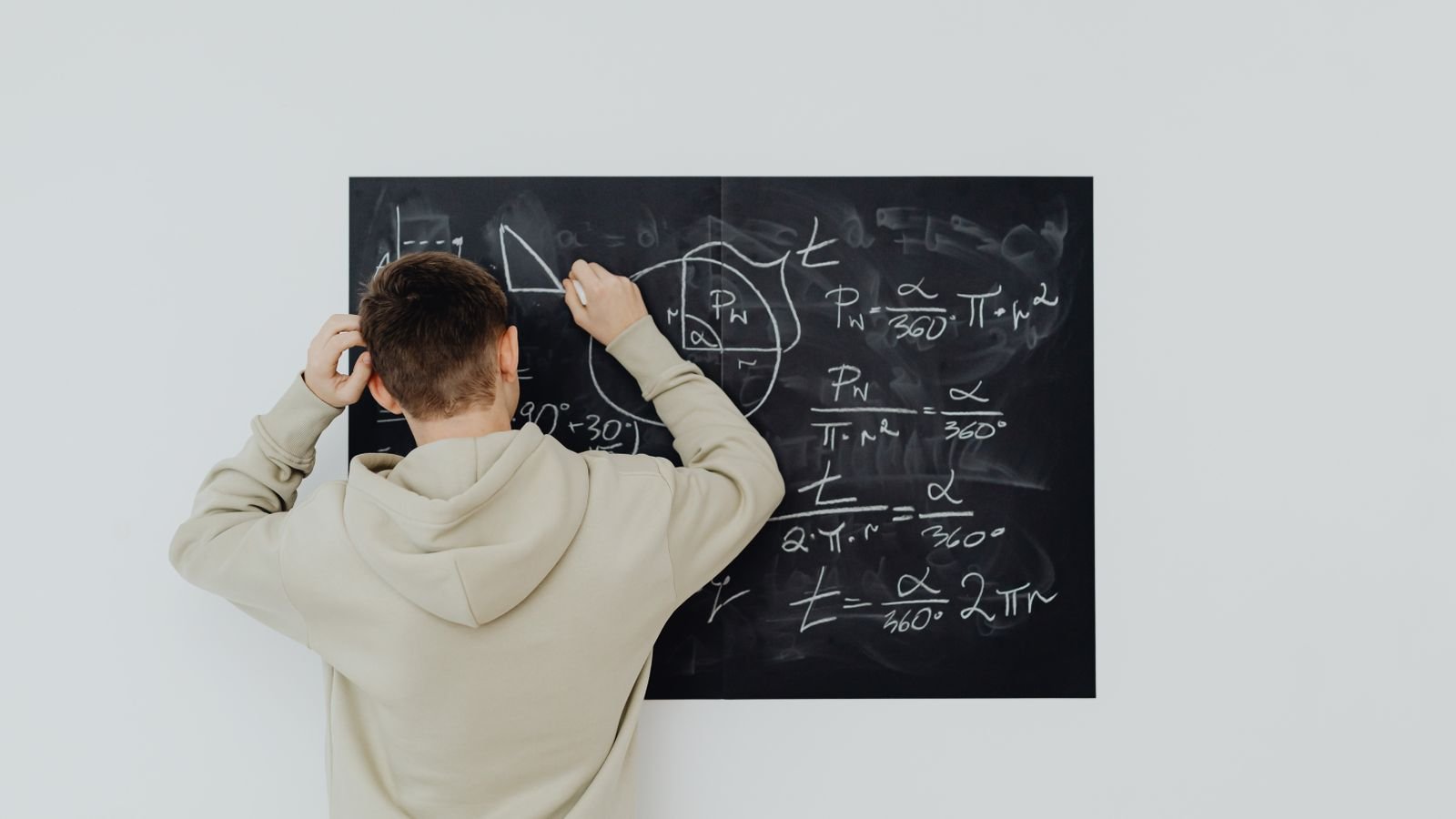 Secondary school student working on algebra in a notebook, showing the step up in maths for children aged 11 to 14