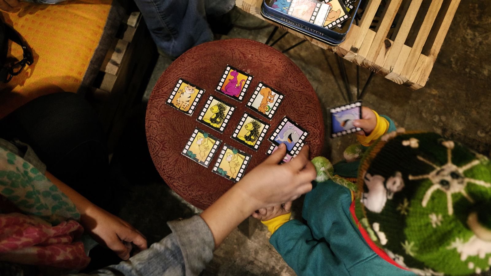 Parent and child playing a screen free maths game at home with cards and dice