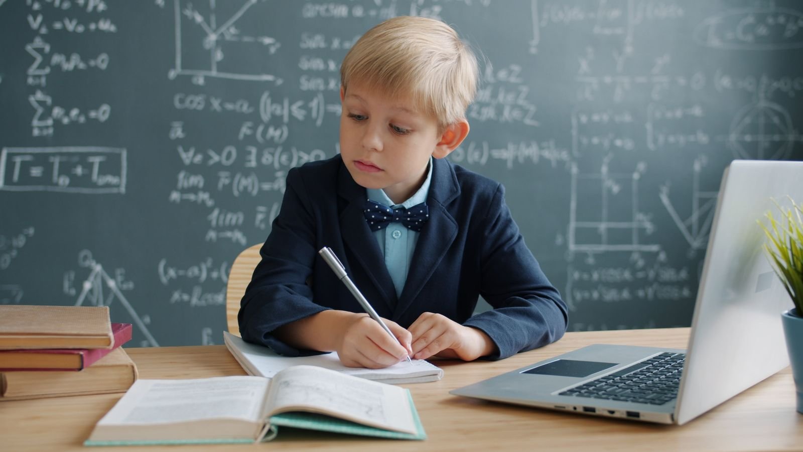 Primary 6 child in Singapore revising PSLE maths at a desk with a parent sitting calmly beside them