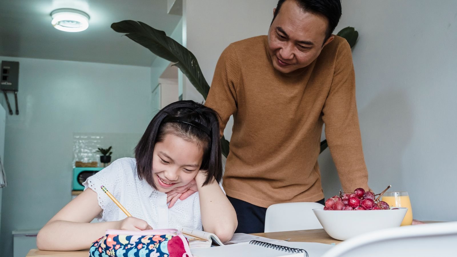 Singapore parent calmly supporting a primary school child studying for the PSLE at home