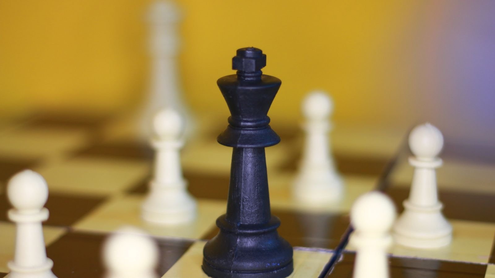 Child moving the king in a king and pawn chess endgame during a chess lesson