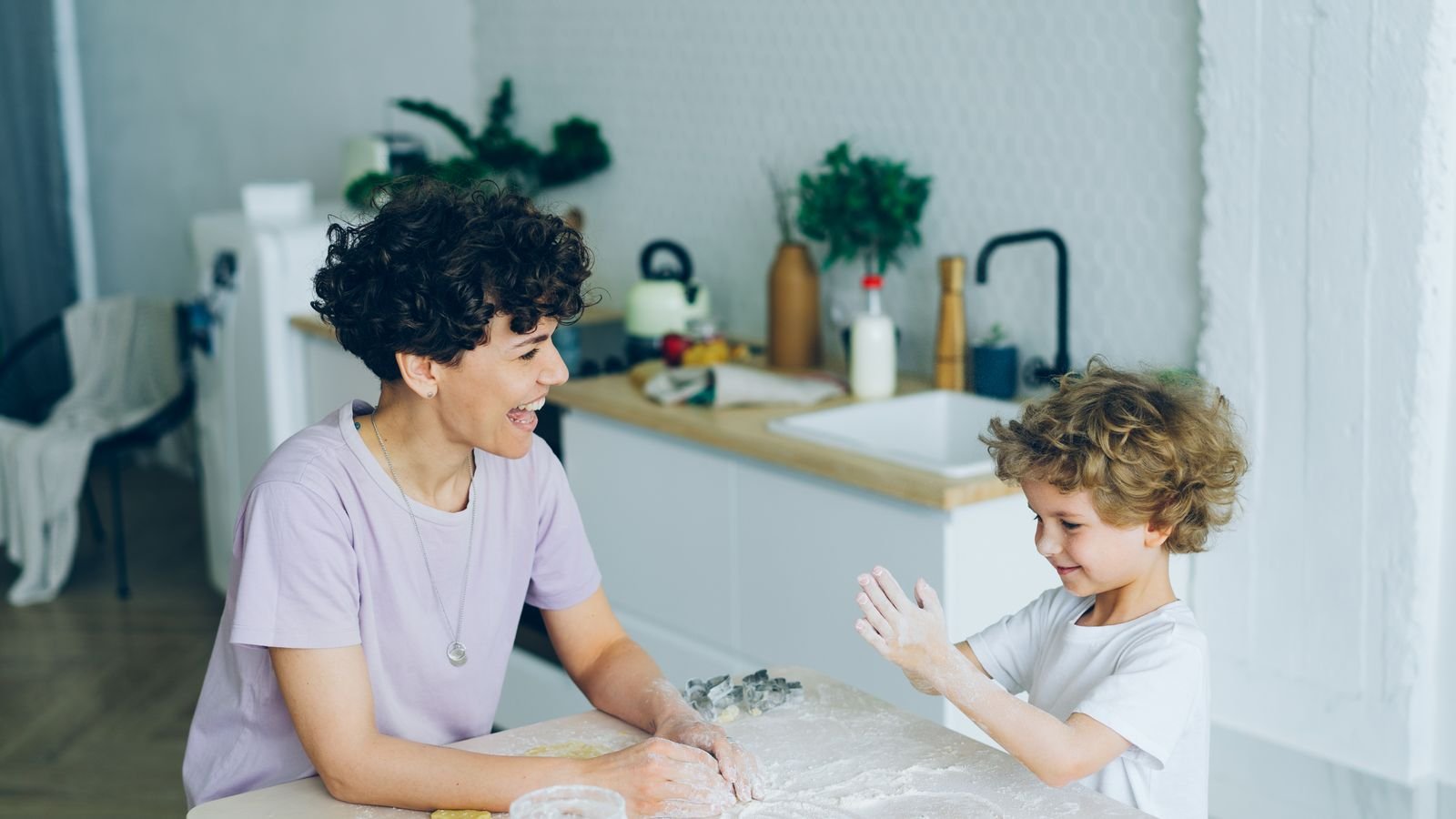 Parent and child practising mental maths together at a kitchen table using everyday numbers