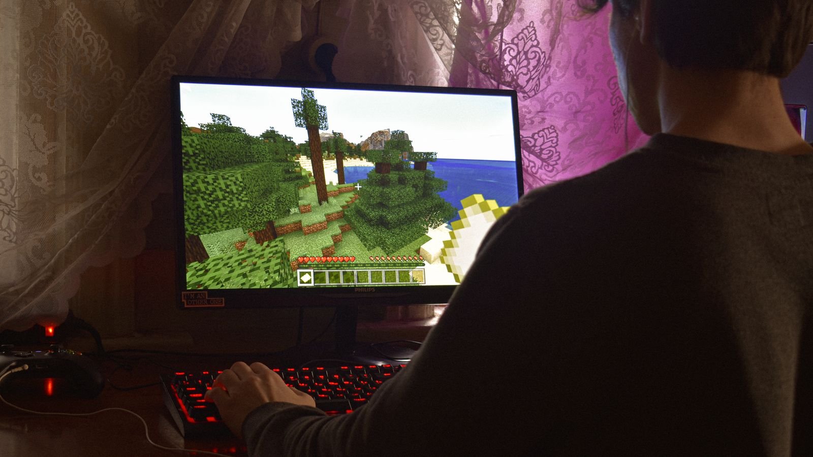 Child engaged in a Minecraft building session on a laptop during screen time