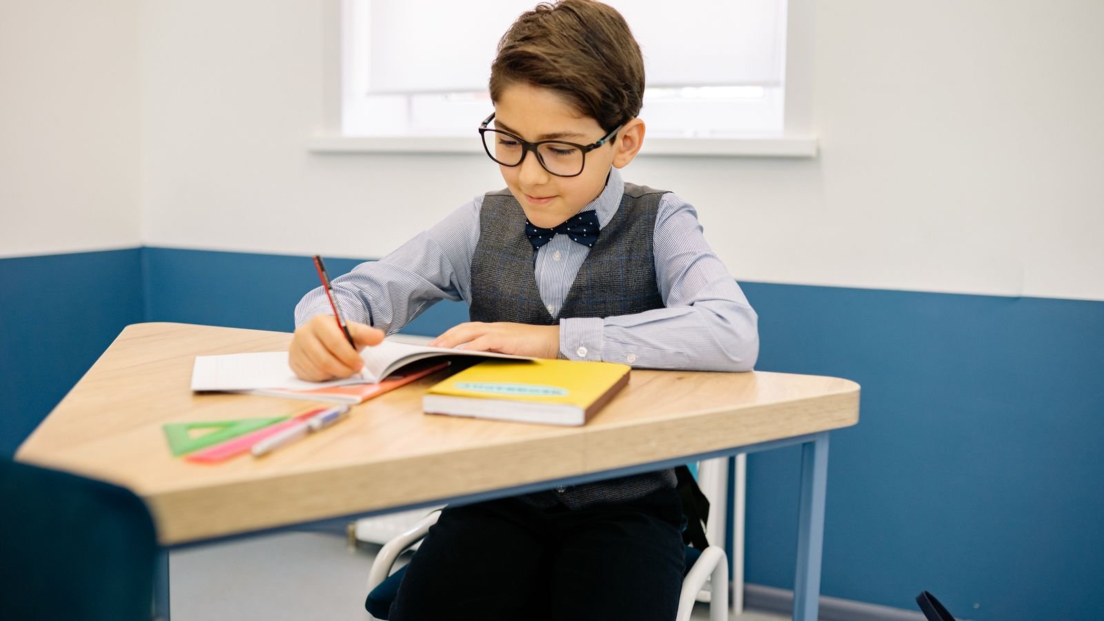 Primary school child revising calmly at a desk while preparing for the PSLE