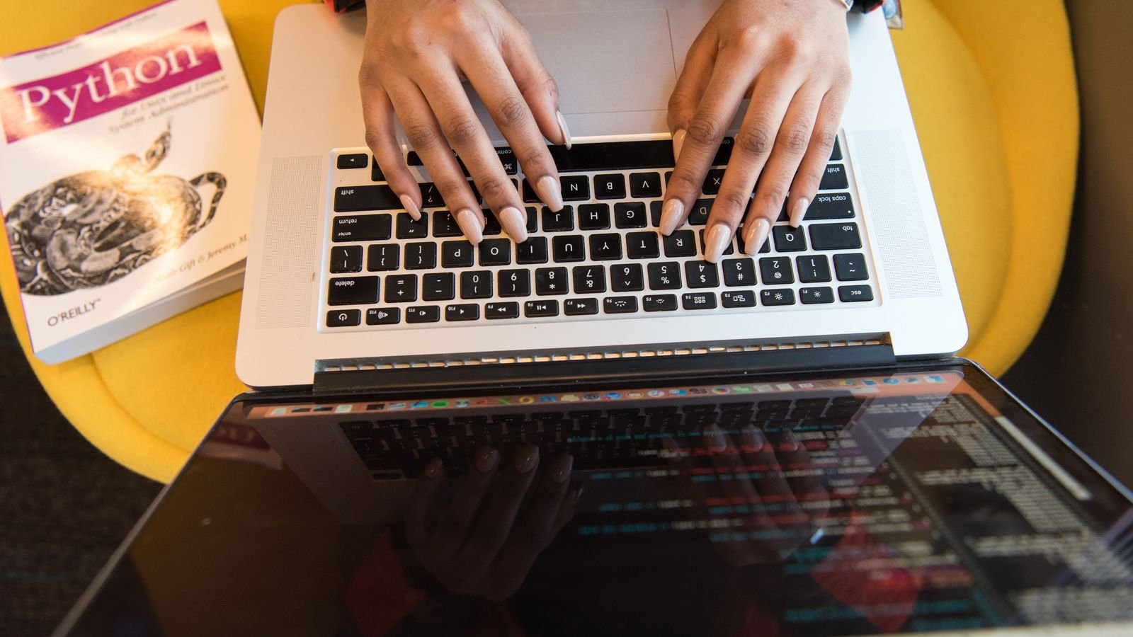 Preteen typing Python code during an online coding lesson for kids