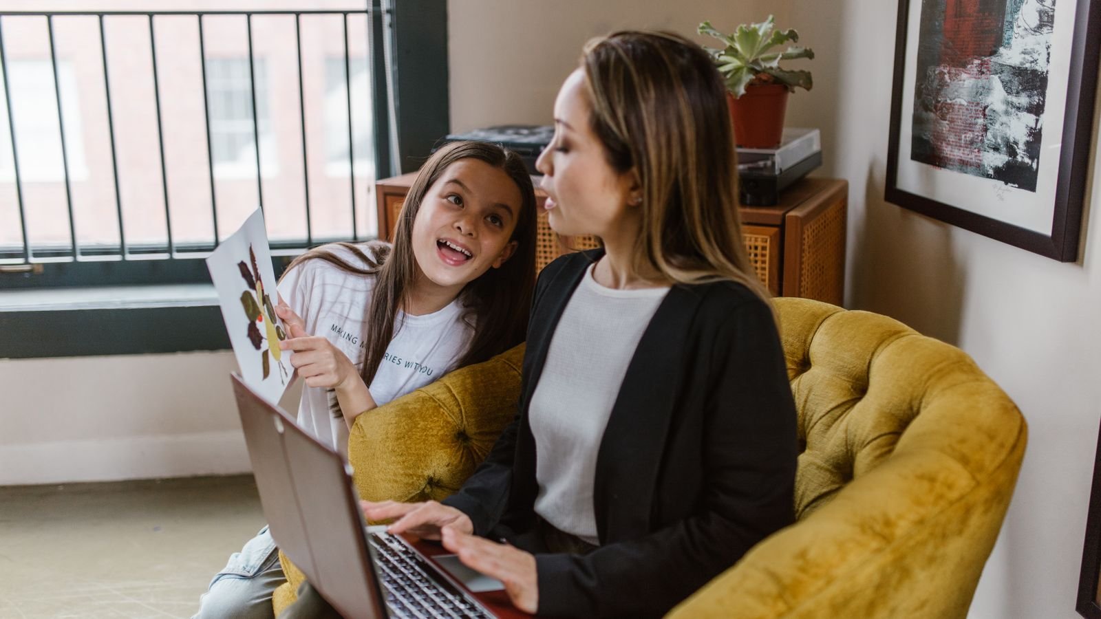 Proud child showing a parent their work after a lesson, one of the signs online classes are working